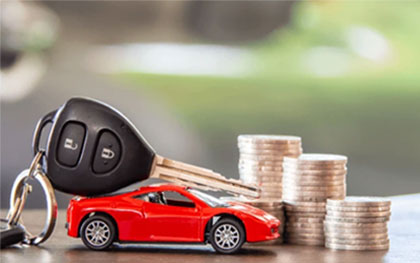 toy car with stack of coins and large car key