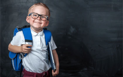 young boy wearing a backpack