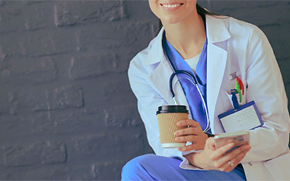 a doctor holding a cup of coffee