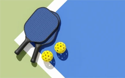 2 pickleball raquets with 2 balls on court