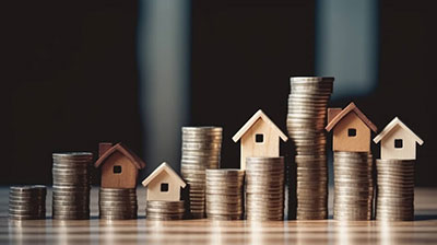 model houses with stacks of coins