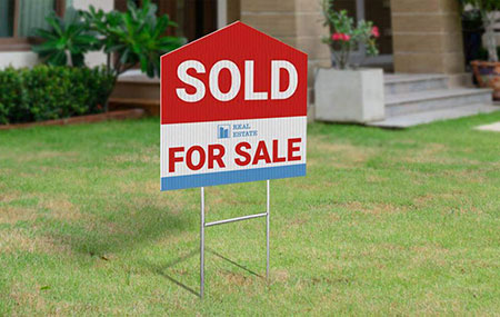 Real Estate sold sign on lawn