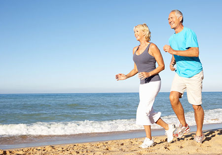 seniors running on beach